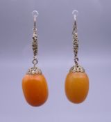 A pair of antique butterscotch amber earrings. Approximately 12.9 grammes total weight.
