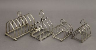 Four silver toast racks. The largest 12.5 cm wide. 11.6 troy ounces.