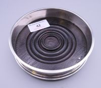A silver wine coaster, hallmarked London 1990. 12.5 cm diameter.