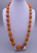 A butterscotch amber string of beads, 29 in total. Approximately 60 grammes.
