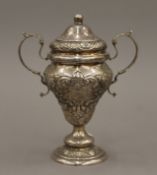 A silver embossed trophy. 16 cm high. 5.9 troy ounces.