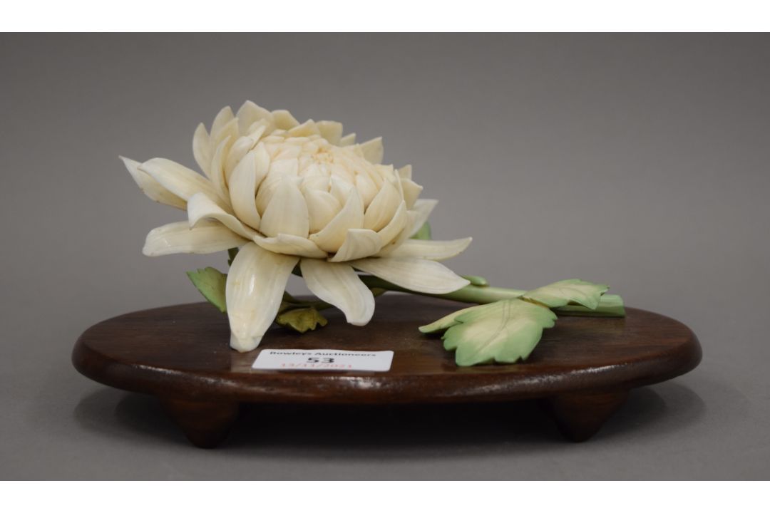 A late 19th century Japanese carved and stained ivory model of a chrysanthemum, - Image 1 of 3