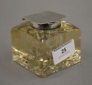 A silver top cut glass inkwell, hallmarked for Birmingham 1920. 6.5 cm high.