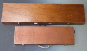 Two shotgun cases, one with fitted interior and metal bound corners (82 x 23 x 8.5cm) the other