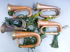 Five military style bugles including Hawkes & Son, A W Gamage Ltd, Hibouville-Lamy & Co with two