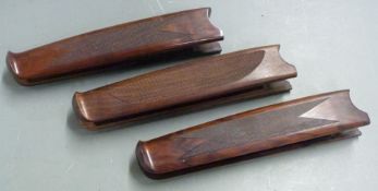Three Beretta chequered shotgun forends, each 26cm long.