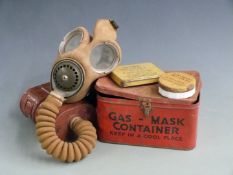 British WW2 gas mask by Avon dated 9/10/40 with broad arrow mark, two anti gas ointment containers