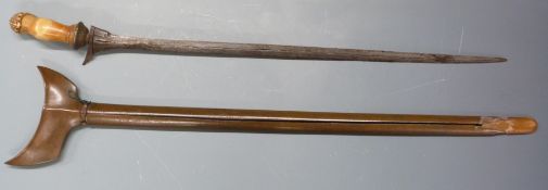 Kris dagger with decorated pommel, wooden sheath and 49cm blade. PLEASE NOTE ALL BLADED ITEMS ARE