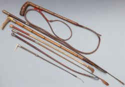 A collection of vintage riding crops, whips and sticks including hallmarked silver mounted examples