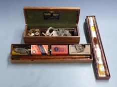 Three shotgun cleaning kits comprising one William Powell & Son with snapcaps and oil bottle in