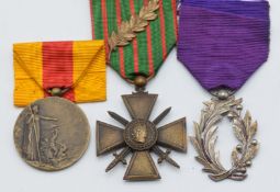 Three French WW1 medals comprising Croix de Guerre with laurel leaf emblem, Ordre de Palmes