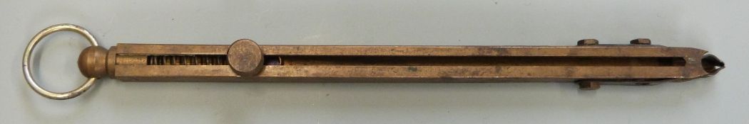 Brass in-line beam sprung percussion cap dispenser with belt loop, 14.5cm long.