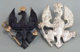 Two British Army 14th/20th Hussars metal cap badges