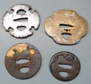 Four Japanese Samurai sword tsuba, some with pierced and gilt decoration, largest 8.5cm in diameter.