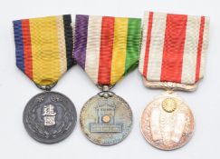 Three Japan medals comprising Manchuko National Foundation medal, Taisho Enthronement medal and