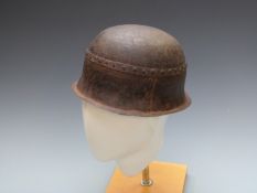 Metal riveted helmet of crude design