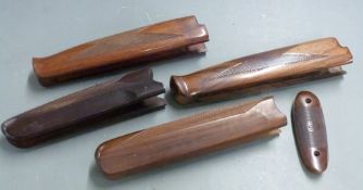 Four chequered shotgun forends including a Browning example together with a Rizzini butt plate.