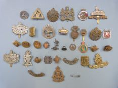 Collection of military badges including Royal Irish Rifles, Gloucestershire Regiment and Royal