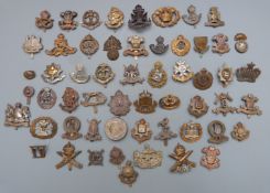 Approximately fifty British Army cap badges including Notts & Derby Regiment, Leinster Regiment,