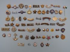 Collection of military badges and shoulder titles including Royal Navy, Royal British Legion,