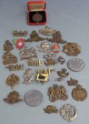 Small collection of British Army cap badges including Leinster Regiment, Tank Corps, Royal Artillery