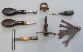 Seven various gun tools including nipple keys and wrenches, multi-spanner set, spring clamp etc.