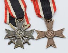 Two German WW2 Third Reich Nazi War Merit Cross medals, one Second Class with crossed swords, the