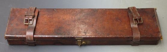 Vintage leather bound gun case with fitted interior and brass lock, 83x23x8cm.