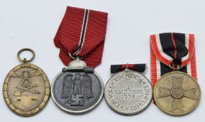 Four German WW2 Third Reich Nazi medals comprising Sudetenland Medal, War Service Medal of Merit,