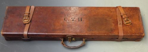 Leather gun case with fitted interior and brass lock, 82x21.5x8cm.