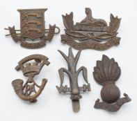 Five British Army Officer's Service Dress badges including Welsh Horse, Essex Regiment, Somerset