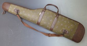 Padded shotgun or rifle slip with decoration of ducks and cartridge bags.