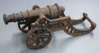 A cast iron signalling or desk cannon with 10 inch graduated barrel, overall length 42cm.