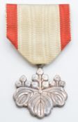 A white metal Japan Order of the Rising Sun medal, in lacquered box