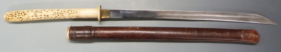 Burmese dha ivory handled sword circa 1900, with ornate carved grip, 54cm plain blade and leather