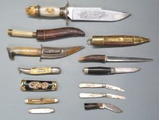 Twelve knives including a Franklin Mint example, two with sheaths, five other penknives etc, largest