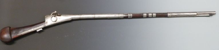 Afghan or Middle Eastern matchlock gun with engraved white metal decoration, metal ram-rod, barrel
