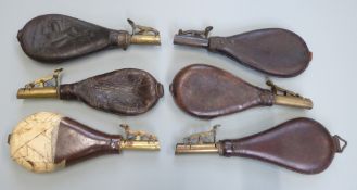 Six leather shot flasks some with embossed decoration and belt loops, one Dixon & Sons, largest 25cm