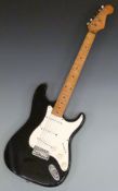 Stratocaster style electric guitar in black glitter finish with white finger board, in soft Fender