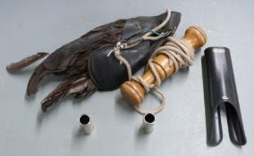 A falconry lure together with 12 bore shotgun snap caps and a forend hand protector.