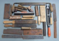 A collection of gun related tools including polishing rasps, barrel polishing blocks, pinfire