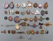 Approximately forty Armed Forces metal and enamel badges and brooches including Royal Air Force,