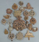 Twenty-two British Army metal badges including Middlesex Regiment, Northamptonshire Regiment, Border