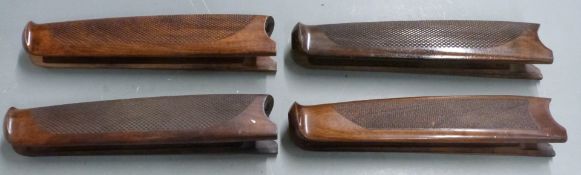 Four Beretta chequered shotgun forends, each 26cm long.
