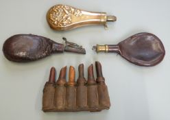Three powder or shot flasks together with a set of six leather bound wooden powder horns.