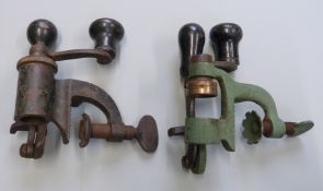 Two 16 bore shotgun cartridge re-loading rollover tools, both with turned wooden handles.