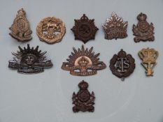 Ten British / Colonial Forces badges, seven being economy issue including Intelligence Corps,