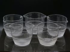 A set of five cut clear glass wine rinsing bowls with double spouts, each approximately 14cm in
