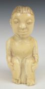 African 19thC carved ivory figure of a seated man, H11cm