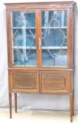 Edwardian astragal glazed mahogany display cabinet with cupboard under, raised on squared tapering